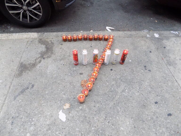 Zamar Jones' neighbors placed candles, balloons, and roses in front of his home in early August. (Ximena Conde/WHYY)
