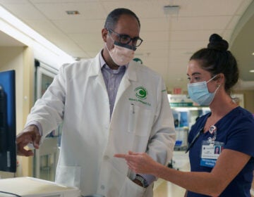 Dr. Mike Benninghoff confers with registered nurse Lea Robbins in Christiana Hospital's intensive care unit for COVID-19 patients. (Courtesy of ChristianaCare)