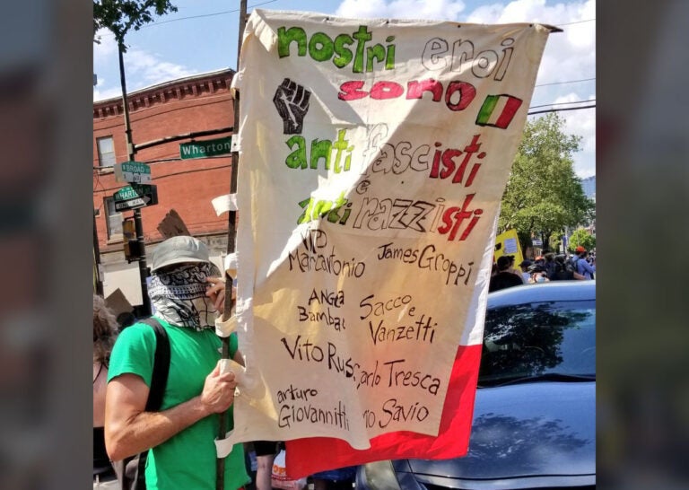 A protester carries a sign in Italian that reads 