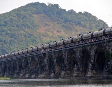 A tanker train crosses the Susquehanna River in Pennsylvania. A proposed new rule that would allow liquefied natural gas to be transported by rail is being challenged because safety and risk assessments have not been done. (Emma Lee/WHYY)