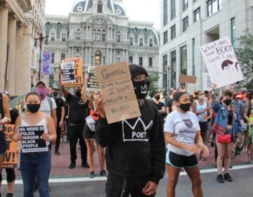 Protesters march south on Broad Street after a rally at City Hall demanding justice for Jacob Blake, a Black man who was shot by police in Kenosha, Wisconsin. (Emma Lee/WHYY)