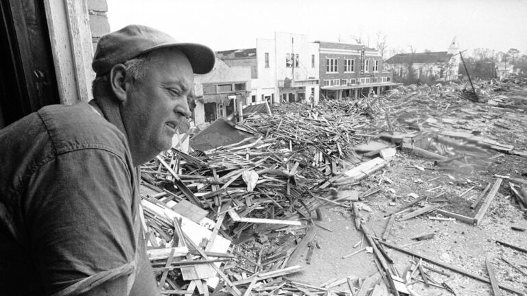 Parnell McKay, the civil defense director of Pass Christian, Miss., looks over the town's main business district on Aug. 23, 1969 after Hurricane Camille passed through. (Jack Thornell/AP Photo)