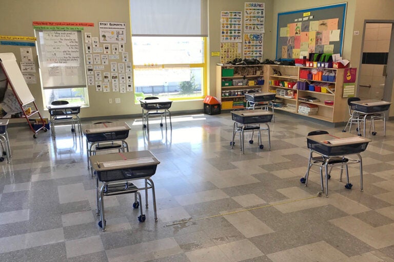 Desks are spaced out 6-feet apart in a classroom.