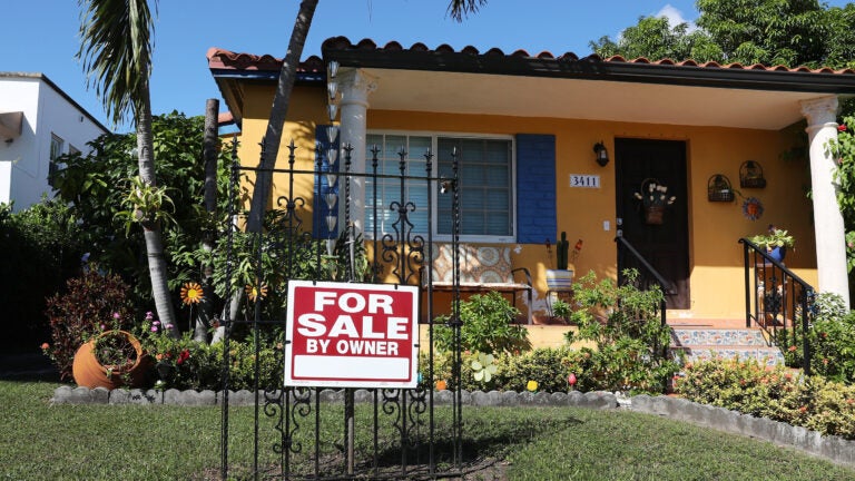 A sale sign is seen in front of a home in Miami. FHA loans are used by many minority, lower-income, and first-time homebuyers because the low down payments make homeownership more affordable. But this demographic is more likely to be hurt financially during the pandemic, and many FHA borrowers are skipping mortgage payments. (Joe Raedle/Getty Images)