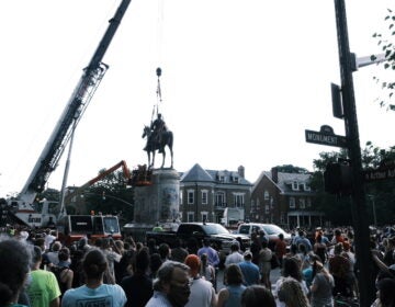 A crowd watches as a crane removes the Stonewall Jackson Monument in Richmond, Va., on July 1. Dozens of Confederate monuments have come down this summer. (Eze Amos/Getty Images)