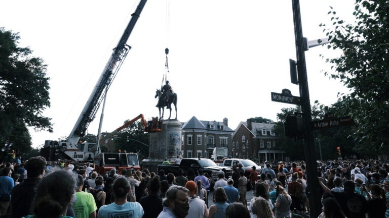 A crowd watches as a crane removes the Stonewall Jackson Monument in Richmond, Va., on July 1. Dozens of Confederate monuments have come down this summer. (Eze Amos/Getty Images)