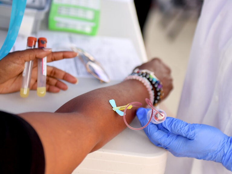 A medical worker draws blood at a free COVID-19 SARS-CoV-2 serology antibody testing community event in Los Angeles on Wednesday. (Matt Winkelmeyer/Getty Images)