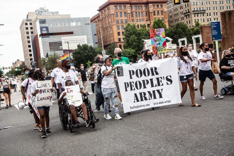 About 50 protesters marched against inequity in Center City Monday.