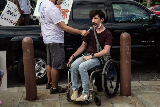 Liam, an organizer from Adapt, demanded equal healthcare for people with disabilities