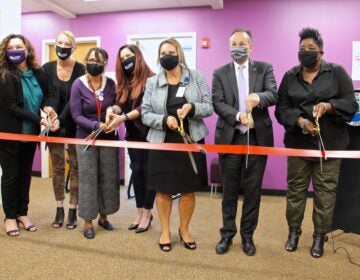 Burlington County officials, including (from right) County Commissioner Director Felicia Hopson and Prosecutor Scott Coffina, cut the ribbon to open the county's new addiction Recovery Center in Westampton, N.J.. (Emma Lee/WHYY)