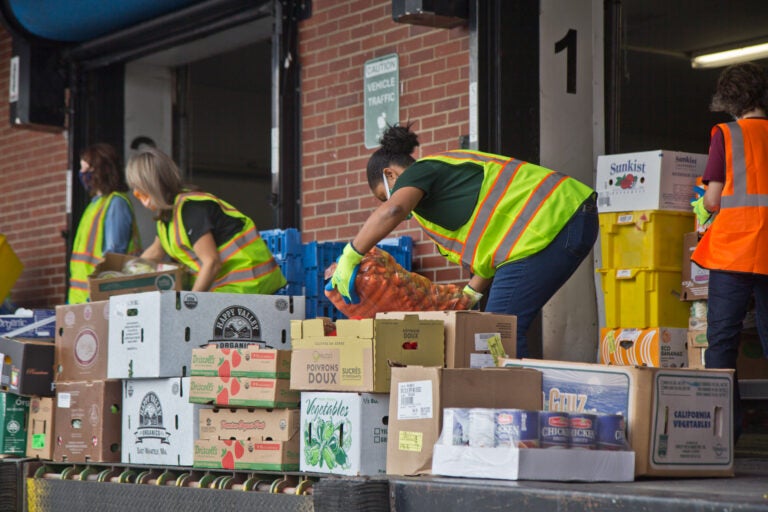 Philadbundance staff and volunteers were joined by DHS employees Friday to help load trucks of Philadelphia food for organizations in need. (Kimberly Paynter/WHYY)