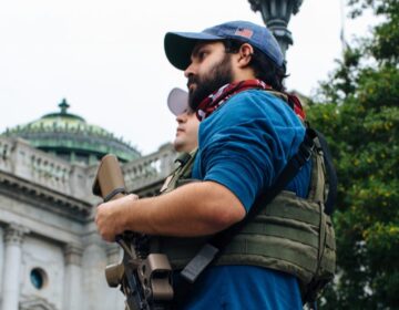 An attendee holds his weapon at the Rally to Protect Your Right to Keep and Bear Arms at the state Capitol on September 29, 2020. (Kate Landis/WITF)