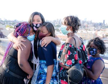 Lady B embraces students after seeing her biography for the first time. (Sandrien B Photography)