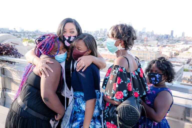 Lady B embraces students after seeing her biography for the first time. (Sandrien B Photography)
