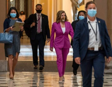 House Speaker Nancy Pelosi of Calif., center, walks to her office, Monday, Sept. 14, 2020, on Capitol Hill in Washington. (AP Photo/Jacquelyn Martin)