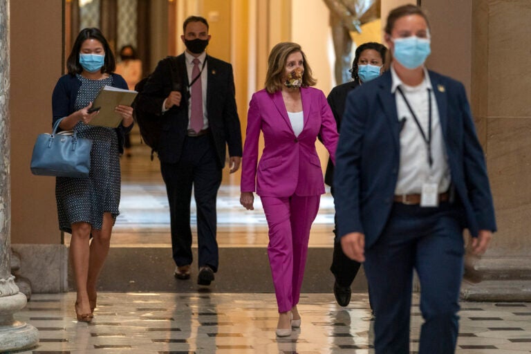 House Speaker Nancy Pelosi of Calif., center, walks to her office, Monday, Sept. 14, 2020, on Capitol Hill in Washington. (AP Photo/Jacquelyn Martin)