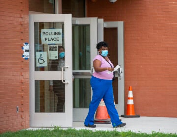 A person walks out of a polling station