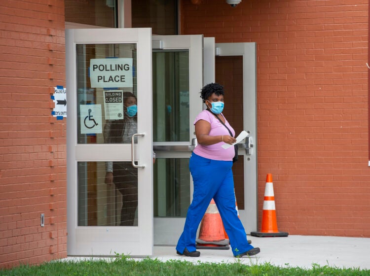 A person walks out of a polling station