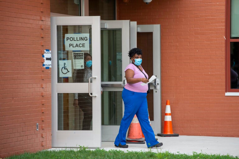 A person walks out of a polling station