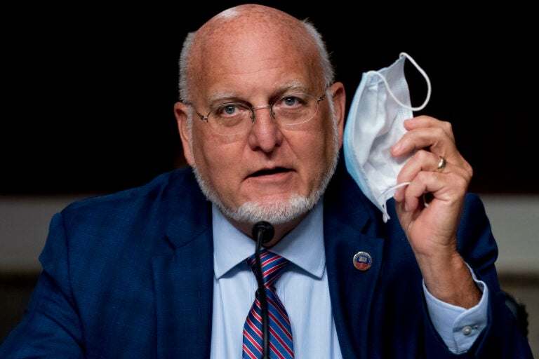 Centers for Disease Control and Prevention Director Dr. Robert Redfield holds up his mask as he speaks at a Senate Appropriations subcommittee hearing on a “Review of Coronavirus Response Efforts” on Capitol Hill, Wednesday, Sept. 16, 2020, in Washington. (AP Photo/Andrew Harnik)