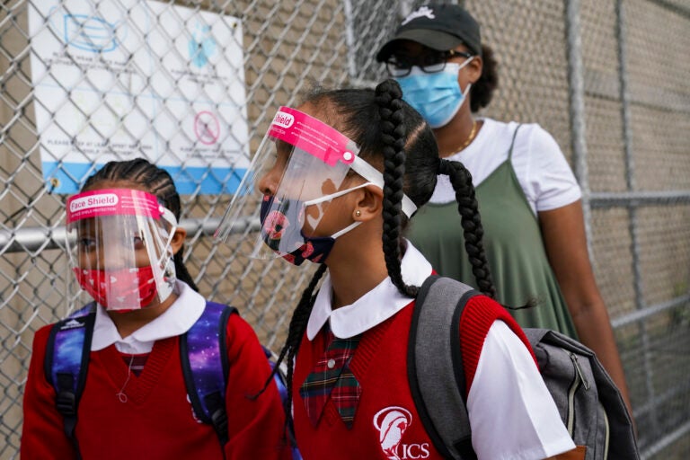 In this Sept. 9, 2020 photo, students wear protective masks as they arrive for classes at the Immaculate Conception School while observing COVID-19 prevention protocols in The Bronx borough of New York. (AP Photo/John Minchillo)