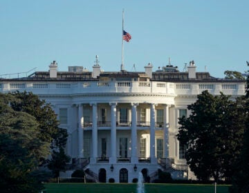 An American flag flies at half-staff over the White House in Washington, Saturday, Sept. 19, 2020. (AP Photo/Patrick Semansky)