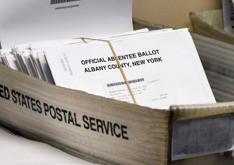 Box of absentee ballots waiting to be counted at the Albany County Board of Elections, Tuesday, June 30, 2020, in Albany, N.Y. (AP Photo/Hans Pennink)