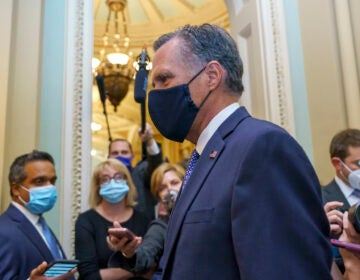 Sen. Mitt Romney, R-Utah, tries to avoid reporters as he leaves the Senate Chamber following a vote, at the Capitol in Washington, Monday, Sept. 21, 2020. (AP Photo/J. Scott Applewhite)