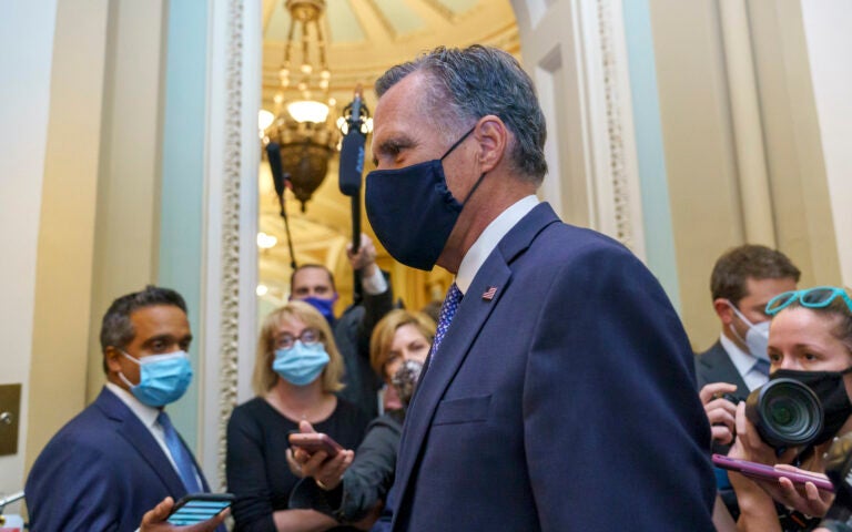 Sen. Mitt Romney, R-Utah, tries to avoid reporters as he leaves the Senate Chamber following a vote, at the Capitol in Washington, Monday, Sept. 21, 2020. (AP Photo/J. Scott Applewhite)