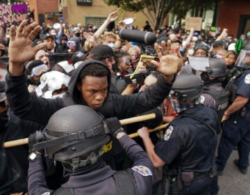 Police and protesters converge during a demonstration, Wednesday, Sept. 23, 2020, in Louisville, Ky. A grand jury has indicted one officer on criminal charges six months after Breonna Taylor was fatally shot by police in Kentucky. The jury presented its decision against fired officer Brett Hankison Wednesday to a judge in Louisville, where the shooting took place. (AP Photo/John Minchillo)