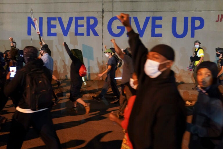 Protesters march, Thursday, Sept. 24, 2020, in Louisville, Ky. Authorities pleaded for calm while activists vowed to fight on Thursday in Kentucky’s largest city, where a gunman wounded two police officers during anguished protests following the decision not to charge officers for killing Breonna Taylor. (AP Photo/John Minchillo)