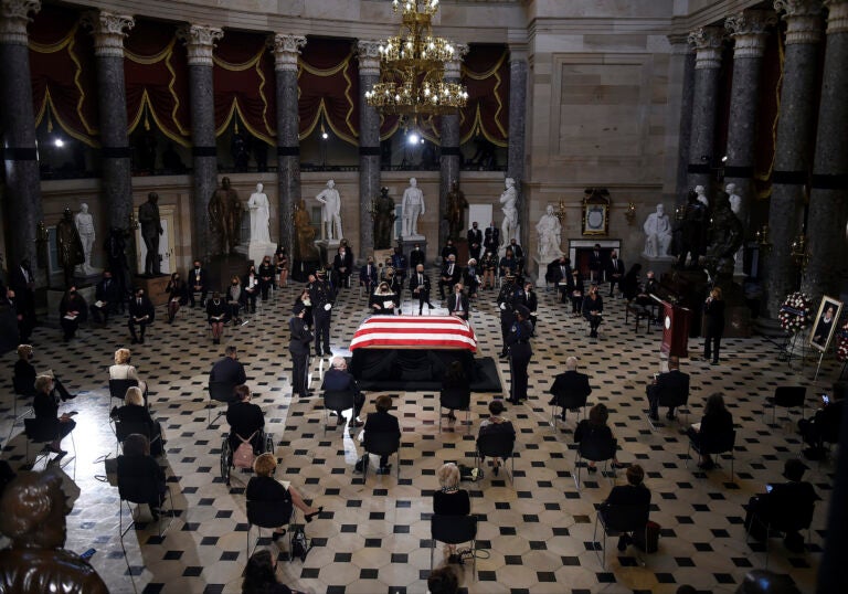 A U.S. Capitol Police honor guard surrounds the flag-draped casket of Justice Ruth Bader Ginsburg as lies in state in Statuary Hall of the U.S. Capitol, Friday, Sept. 25, 2020 in Washington. (Olivier Douliery/Pool via AP)