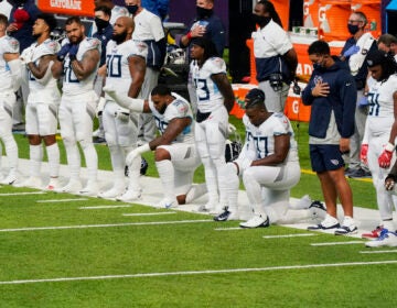 Members of the Tennessee Titans take part in the national anthem before an NFL football game against the Minnesota Vikings, Sunday, Sept. 27, 2020, in Minneapolis. (AP Photo/Jim Mone)