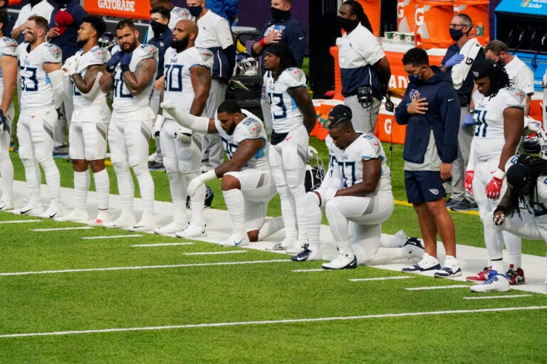 Members of the Tennessee Titans take part in the national anthem before an NFL football game against the Minnesota Vikings, Sunday, Sept. 27, 2020, in Minneapolis. (AP Photo/Jim Mone)