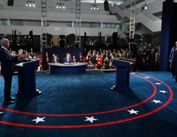 Democratic presidential candidate former Vice President Joe Biden gestures as President Donald Trump walks onto stage for the first presidential debate Tuesday, Sept. 29, 2020, at Case Western University and Cleveland Clinic, in Cleveland. (Olivier Douliery/Pool via AP)