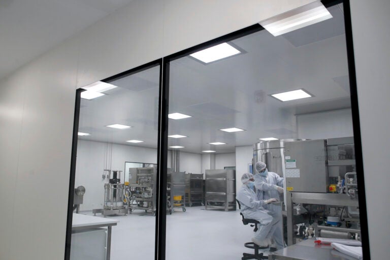 Laboratory technicians work at the mAbxience biopharmaceutical company in Garin, Argentina, Friday, Aug. 14, 2020. Under an agreement between Argentina and Mexico announced this week, the company is going to make an experimental coronavirus vaccine developed by Oxford University and the laboratory AstraZeneca, and if approved the vaccine will be distributed in Latin America. (AP Photo/Natacha Pisarenko)