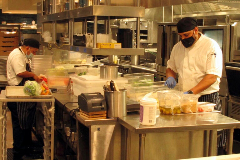 Kitchen workers prepare food in a restaurant inside the Hard Rock casino in Atlantic City N.J. on Sept. 1, 2020. (AP Photo/Wayne Parry)