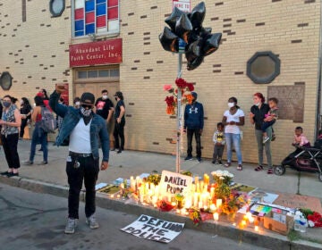 Protesters gather near a memorial to Daniel Prude at the site of his death, Thursday, Sept. 3. 2020 in Rochester, N.Y. Prude, a 41-year-old Black man, died March 30, 2020. His family took him off life support seven days after Rochester police officers encountered him running naked through the street, put a hood over his head to stop him from spitting, then held him down for about two minutes until he stopped breathing. (AP Photo/Ted Shaffrey)