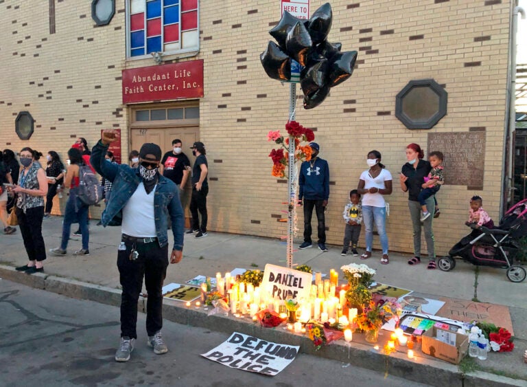 Protesters gather near a memorial to Daniel Prude at the site of his death, Thursday, Sept. 3. 2020 in Rochester, N.Y. Prude, a 41-year-old Black man, died March 30, 2020. His family took him off life support seven days after Rochester police officers encountered him running naked through the street, put a hood over his head to stop him from spitting, then held him down for about two minutes until he stopped breathing. (AP Photo/Ted Shaffrey)