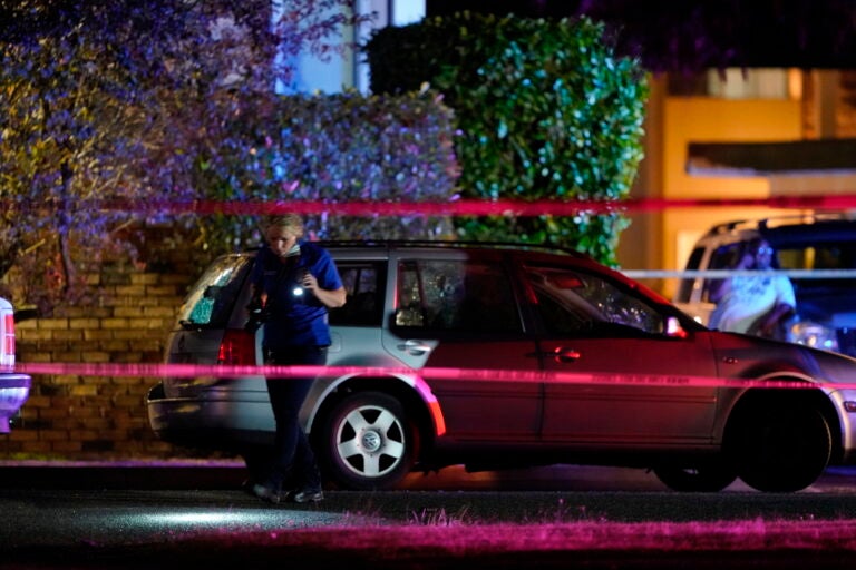 An investigator works at a scene where a man suspected of fatally shooting a supporter of a right-wing group in Portland, Ore., last week was killed as investigators moved in to arrest him in Lacey, Wash., Thursday, Sept. 3, 2020. Michael Reinoehl, 48, was killed as a federal task force attempted to apprehend him in Lacey, a senior Justice Department official said. (AP Photo/Ted Warren)