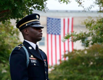 In this Sept. 11, 2019 file photo, a member of the U.S. Army Old Guard stands on the grounds of the National 9/11 Pentagon Memorial before a ceremony in observance of the 18th anniversary of the September 11th attacks at the Pentagon in Washington. (AP Photo/Patrick Semansky)