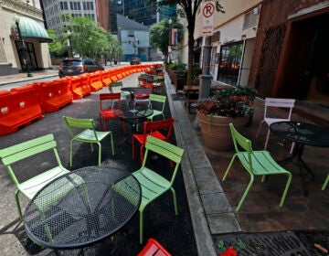 Orange barriers enclose chairs and tables that will be used for dining along Sixth Street between Liberty and Penn avenues