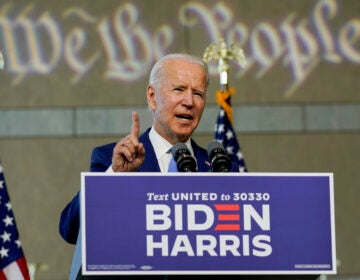 Joe Biden speaks from a podium as 