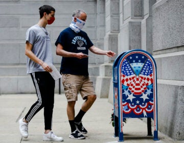 Benjamin Graff and his son Jacob Graff drop off their mail-in ballots for the Pennsylvania primary election