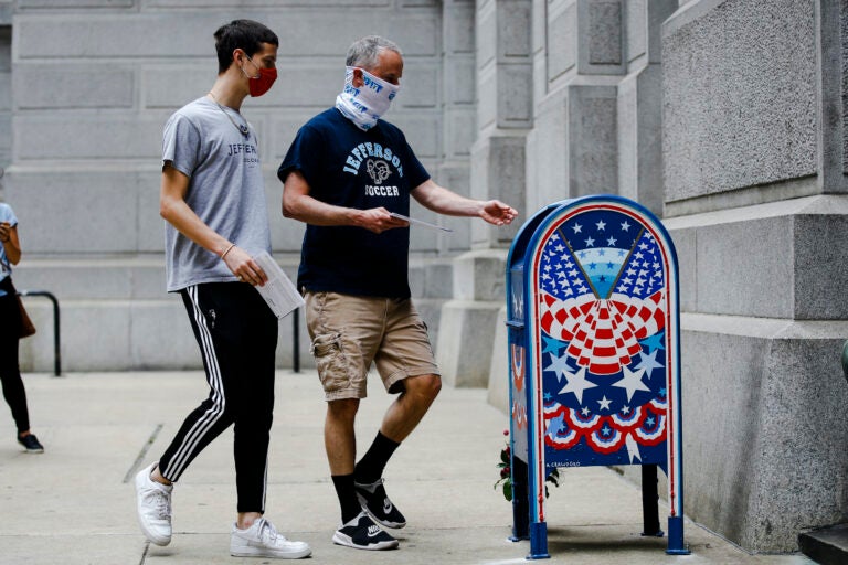 Benjamin Graff and his son Jacob Graff drop off their mail-in ballots for the Pennsylvania primary election