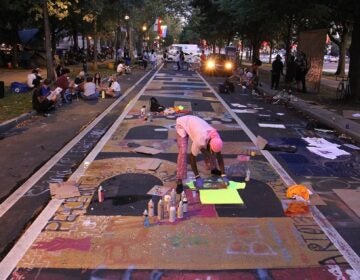 Protesters gather on the Ben Franklin Parkway, where a homeless encampment is under notice from the city that it will be cleared. (Emma Lee/WHYY)