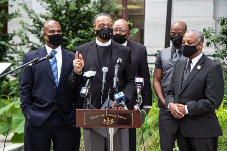 Reverend Robert Collier, president of the Philadelphia Black Clergy (center), urged voters to vote as early as they can. (Kimberly Paynter/WHYY)