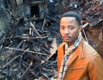 Elena’s Soul Food owner Algernong Allen III stands in front of his restaurant in 2013, after it was destroyed by fire. (Abdul R. Sulayman/The Philadelphia Tribune)
