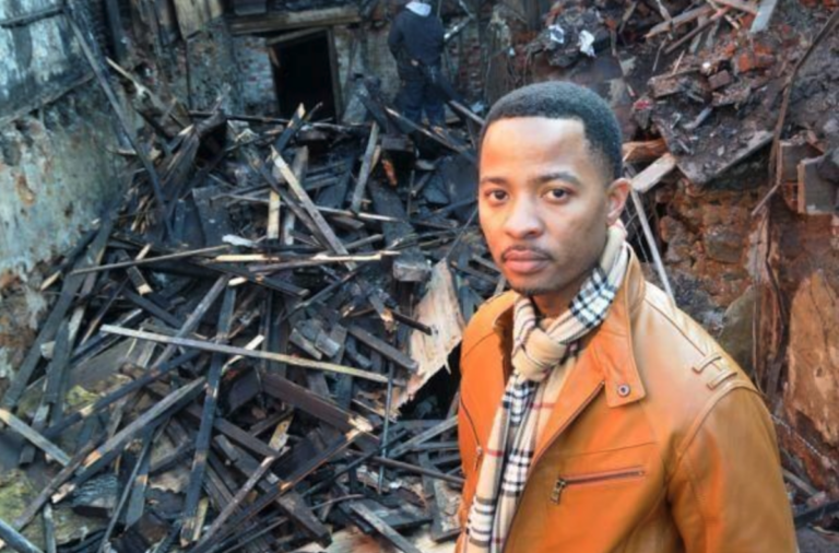 Elena’s Soul Food owner Algernong Allen III stands in front of his restaurant in 2013, after it was destroyed by fire. (Abdul R. Sulayman/The Philadelphia Tribune)
