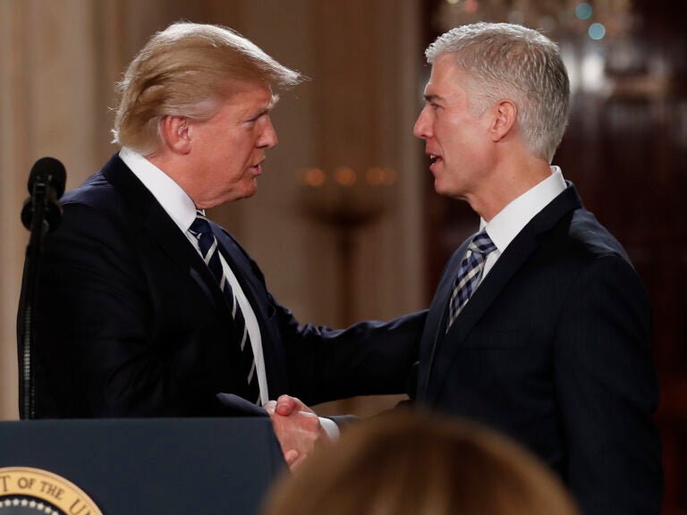 President Trump shakes hands with Neil Gorsuch, his first pick for a spot on the U.S. Supreme Court, on Jan. 31, 2017. The president will likely have the opportunity to name a replacement for Justice Ruth Bader Ginsburg, who died Friday. (Carolyn Kaster/AP Photo)